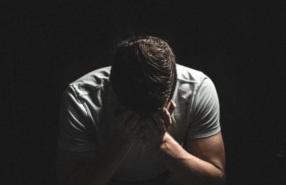 Man With Hands Covering His Face
