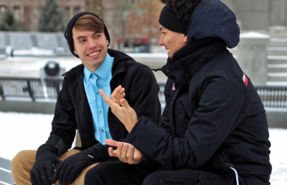 Two guys having a conversation on a park bench