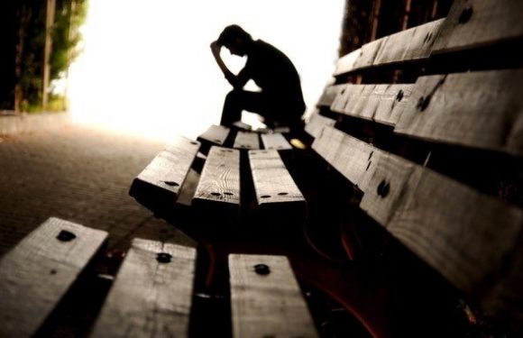 Man sitting alone on a bench