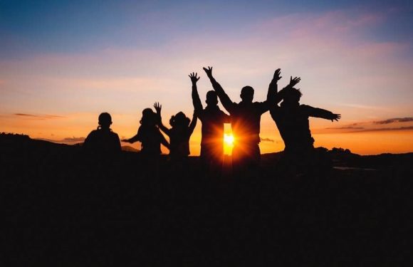 Silhouette of kids in front of a sunset