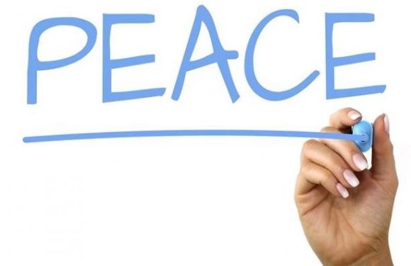 hand writing the word peace