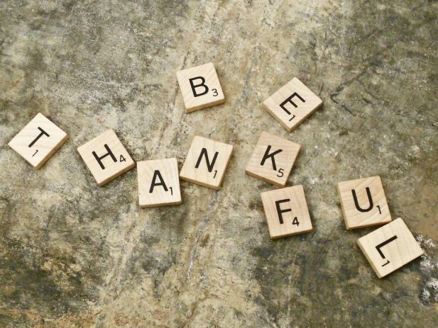 Scrabble Letters spelling out "Be Thankful"