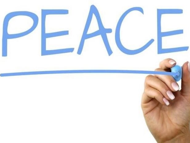 hand writing the word peace